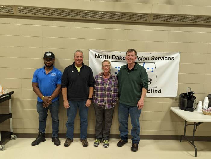 Greg stands next to 3 of his fellow maintenance workers at a maintenance appreciation celebration a couple of years ago.