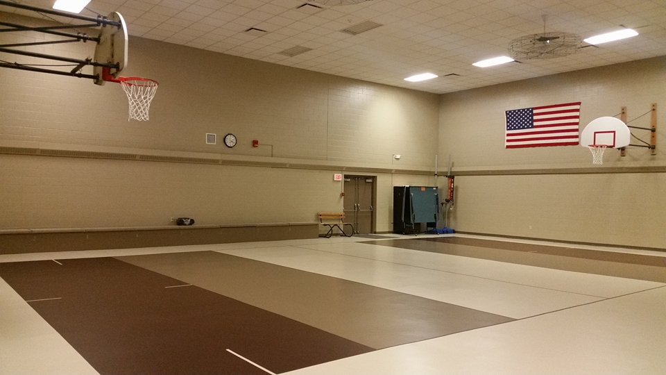 new gym floor shows goalball lines and new tan walls